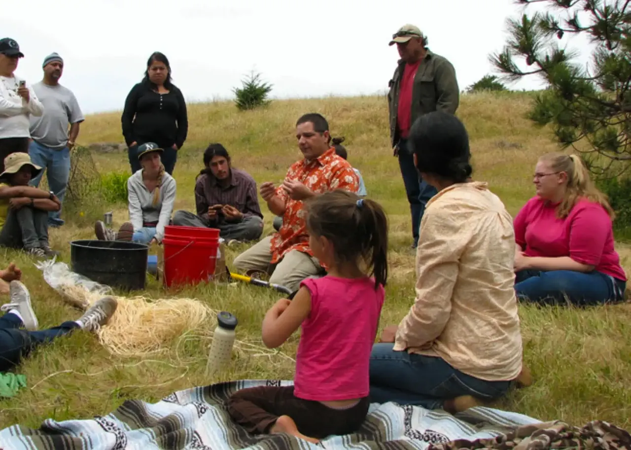 An Amah Mutsun leader sharing native plant knowledge with Tribal members and the public at the UCSC Arboretum